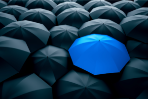 Blue Umbrella Among Black Umbrellas
