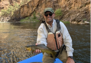 Mike Jaynes On A Boat Holding A Fish