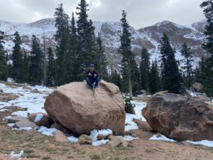 Guy sitting on a boulder
